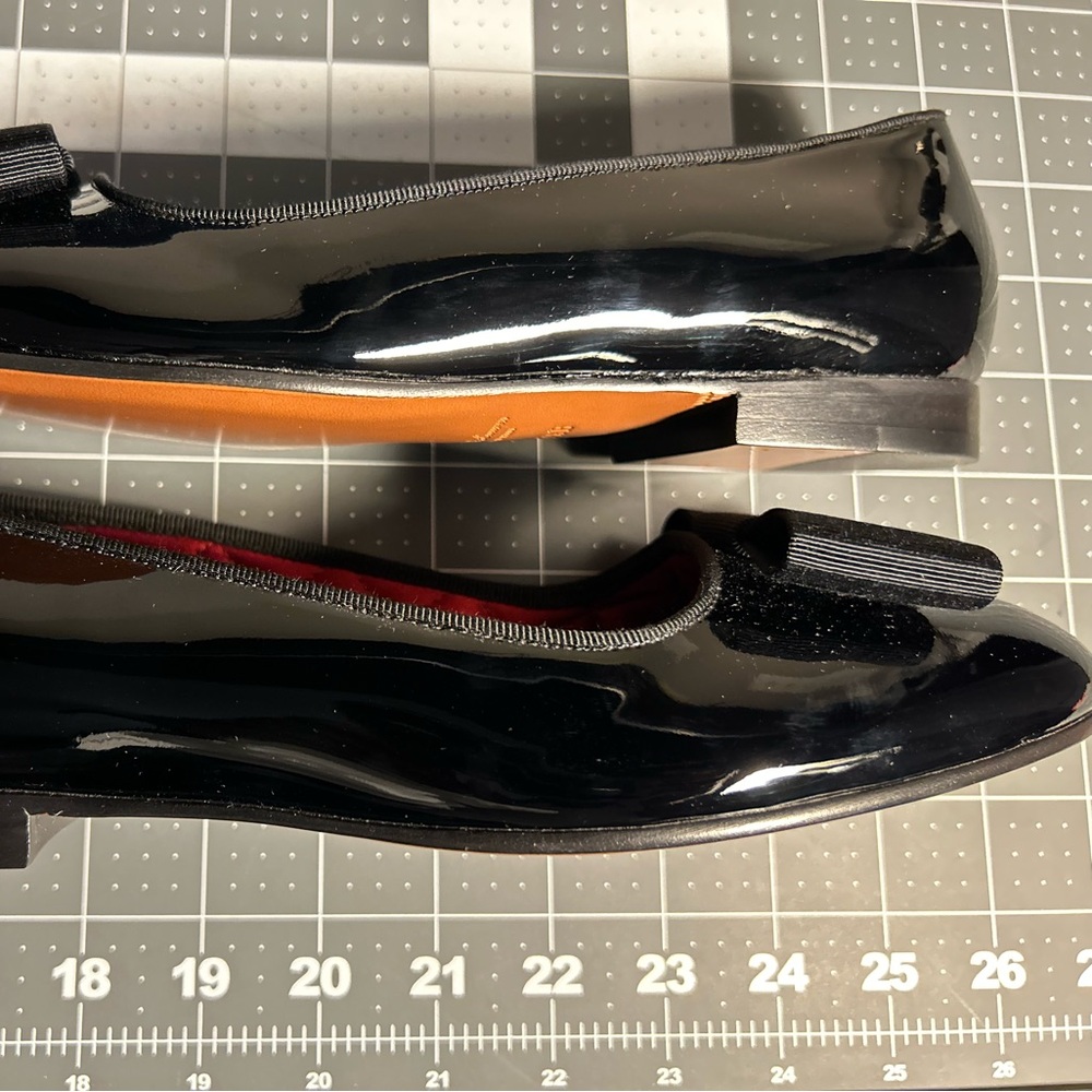 Black Purple Label Patent leather flats with bow and quilted interior.